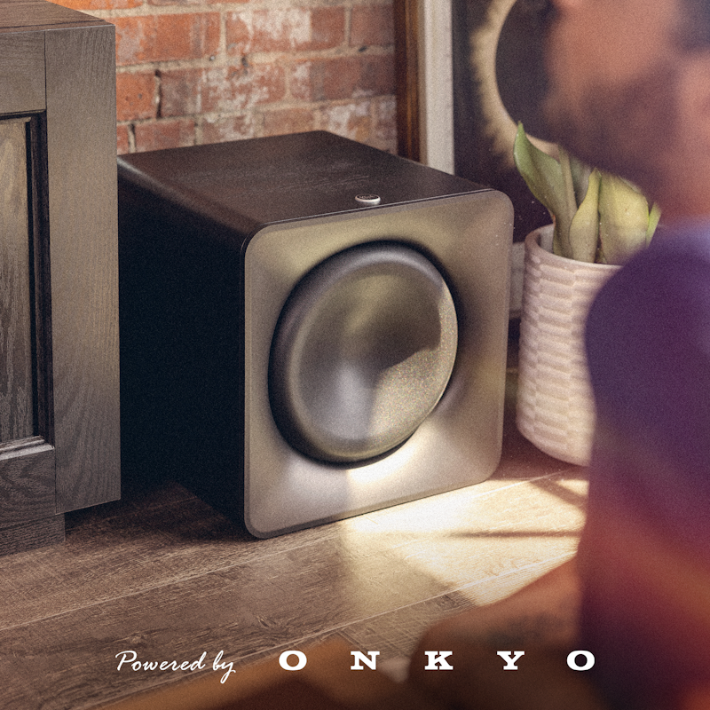 Flexus SUB 200 beside media cabinet and potted plant on brick wall 2000x2000 5