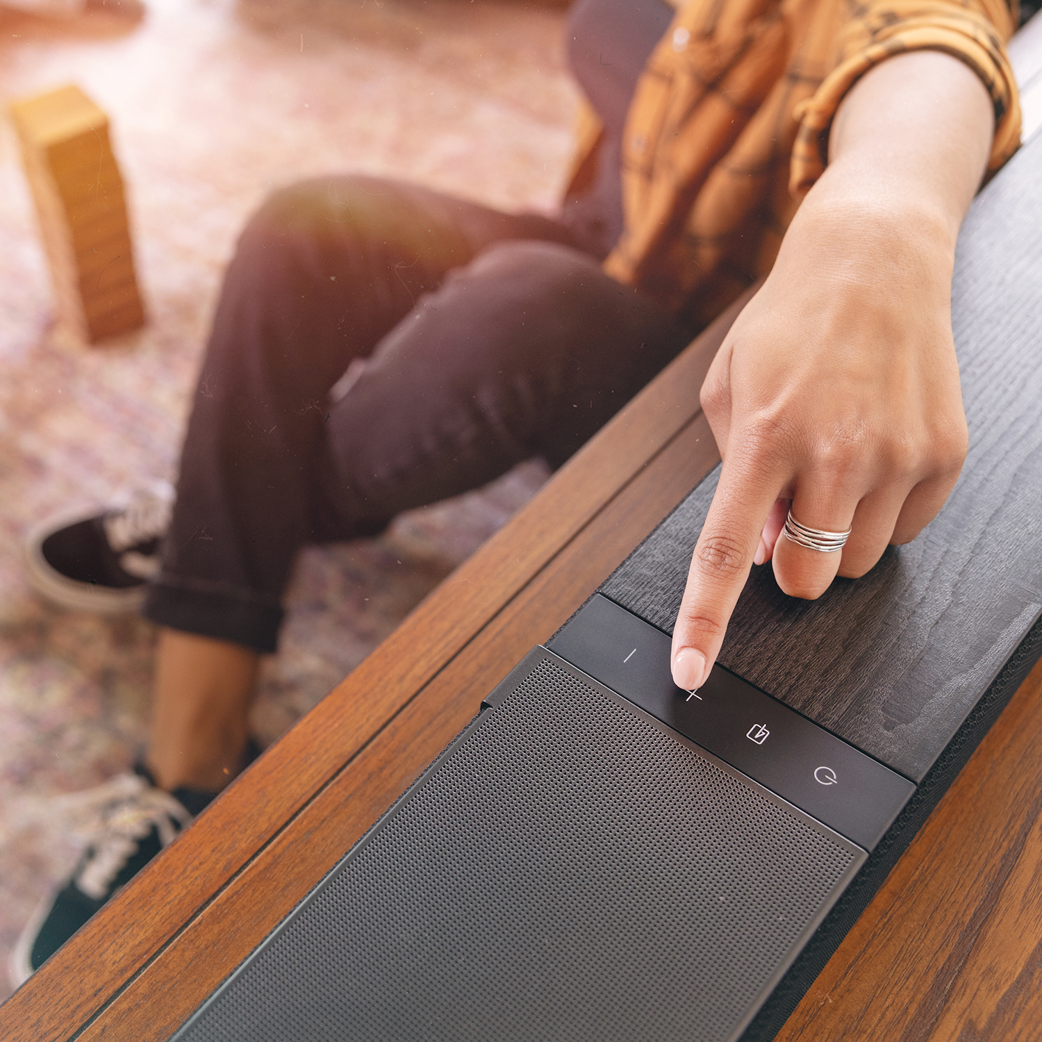 Klipsch Flexus womans finger pushing button on CORE 300 BK 2000x2000 2