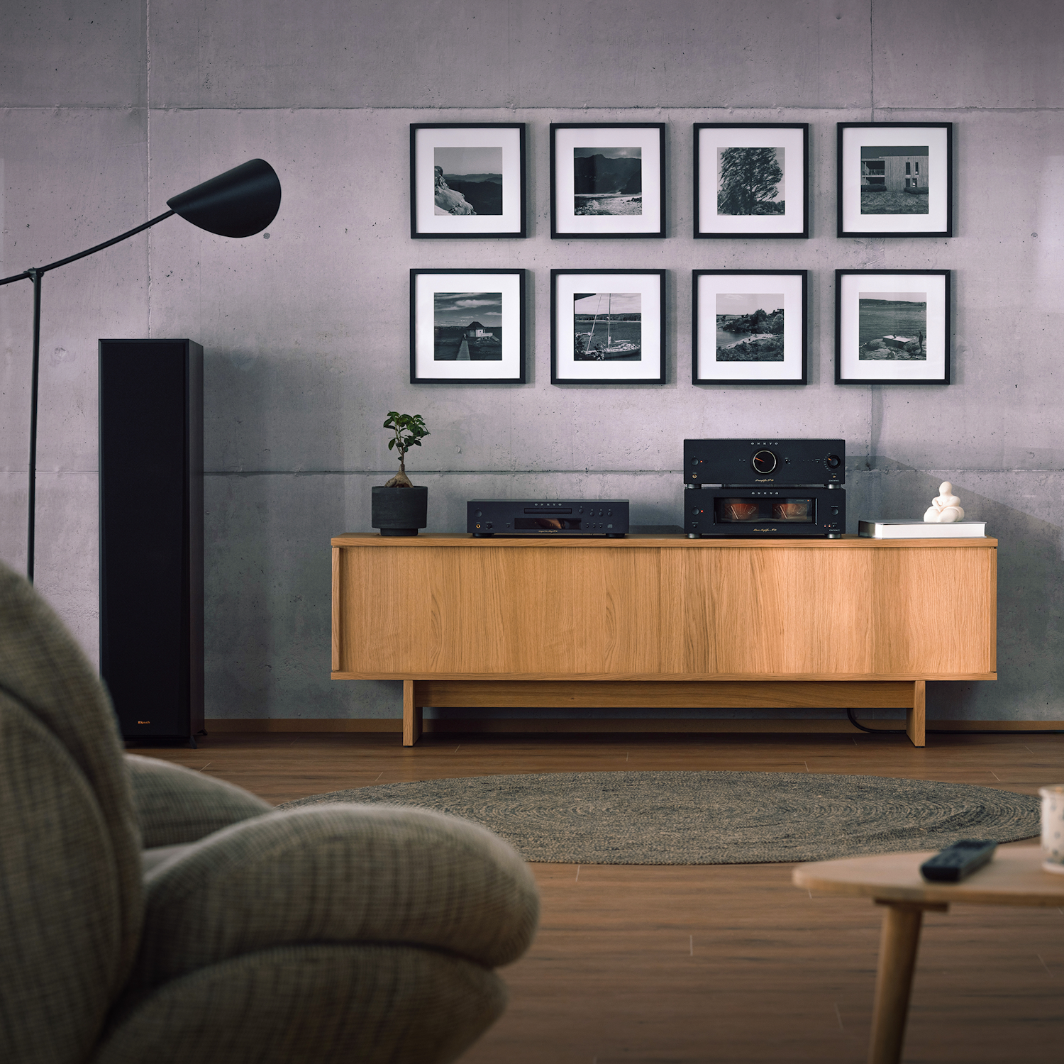 Onkyo Icon P 80 M 80 and C 30 black in listening room with Klipsch speakers gallery wall and lounge chair in blurred foreground 2000x2000